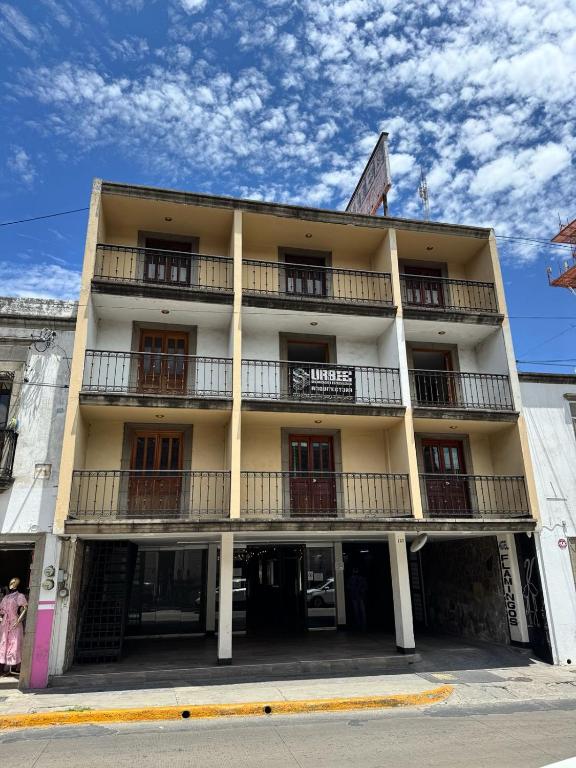 a tall building with balconies on the side of it at HOTEL FLAMINGOS DE CIUDAD GUZMAN in Ciudad Guzmán