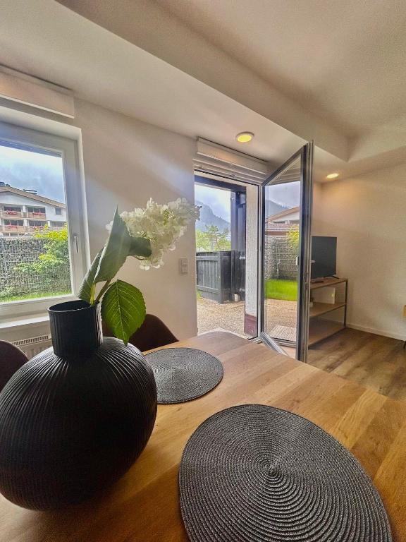 a room with a table with a vase on it at Jagdhof Apartments am Spitzingsee in Schliersee