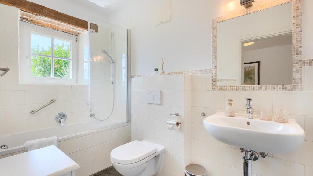 a white bathroom with a sink and a toilet at Villa Pigini by Villas Guide in Livade