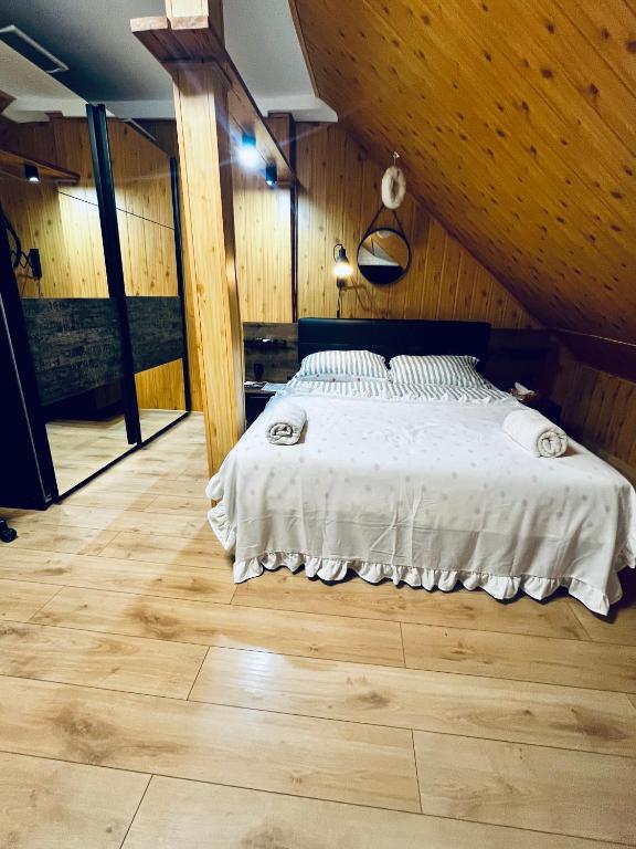 a bedroom with a bed in a room with wooden walls at Agro Bieszczady 2 in Czarna