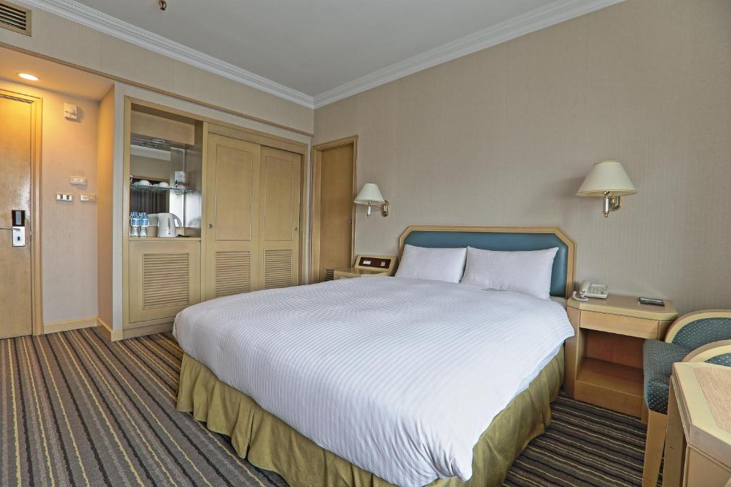 Postel nebo postele na pokoji v ubytování Santos Hotel