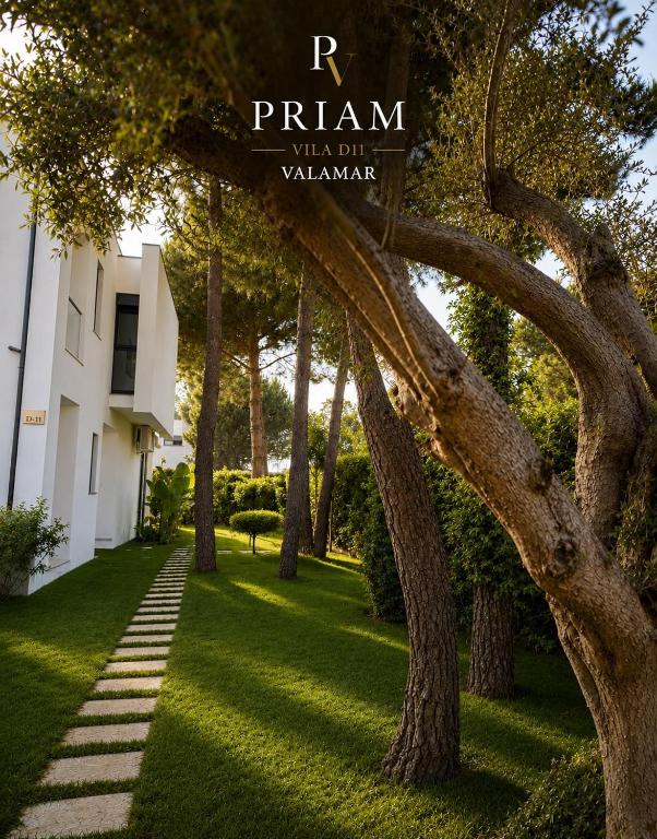 a garden with trees and a sign that reads r train mega club villas at Valamar Priam Villa D11 in Hamallë