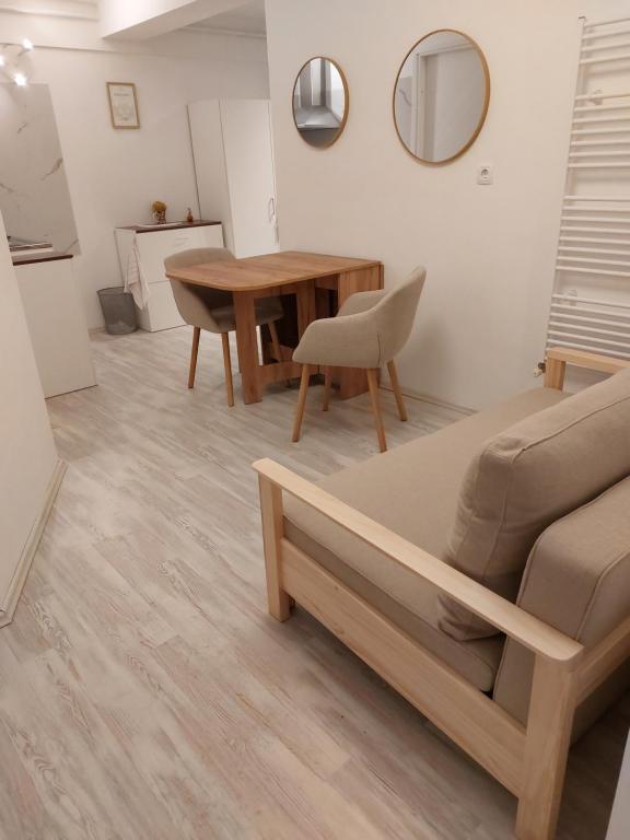 a living room with a table and a couch at Juraj apartman studio in Brdovec