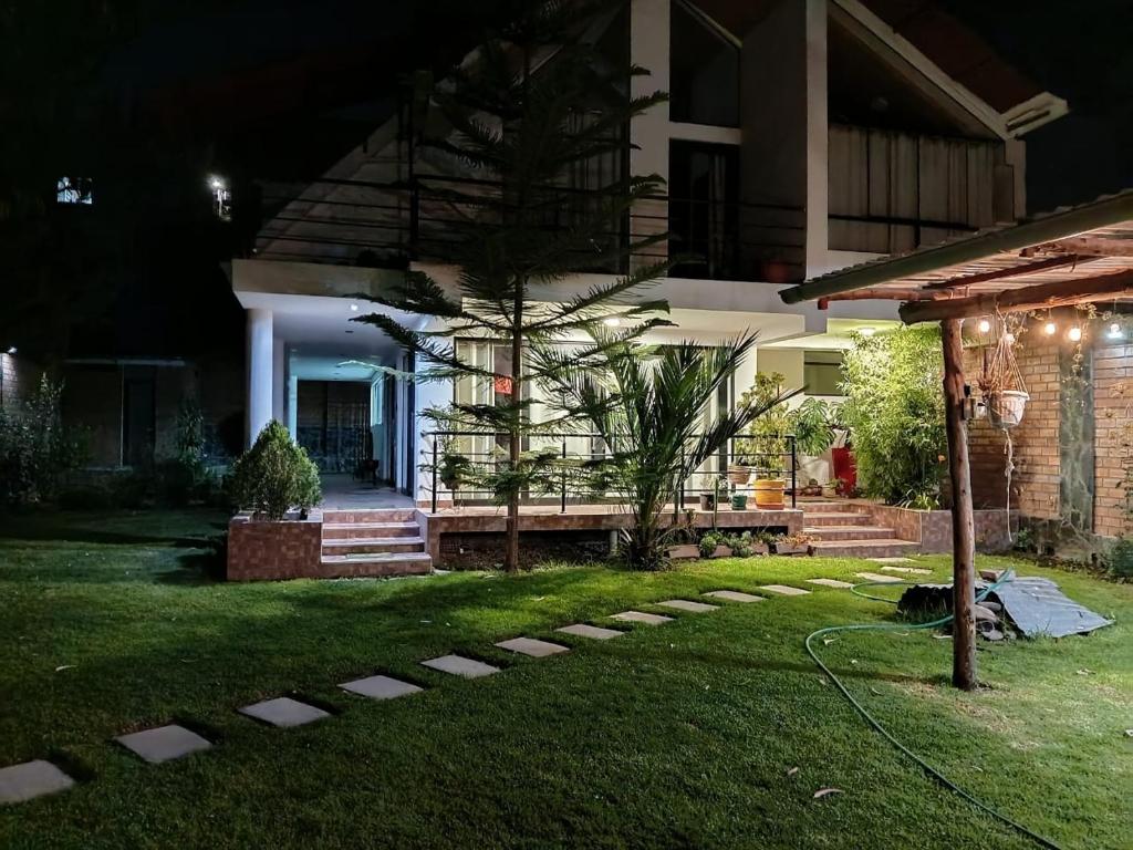 a house with a garden at night at Casa Munay in Huancayo