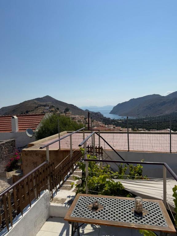 a balcony with a table and a view of the ocean at Marthas Traditional House in Symi