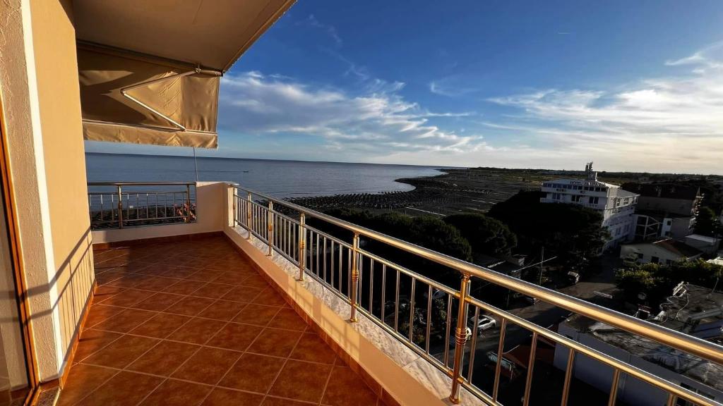 a balcony with a view of the ocean at Erjani Hotel in Velipojë