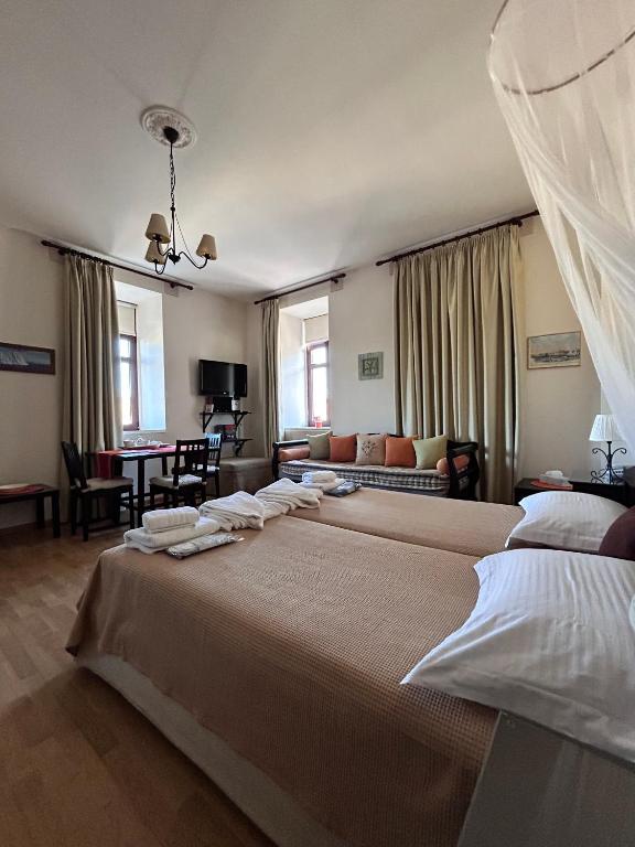 a bedroom with two beds and a living room at Archontiko Tsikari in Város