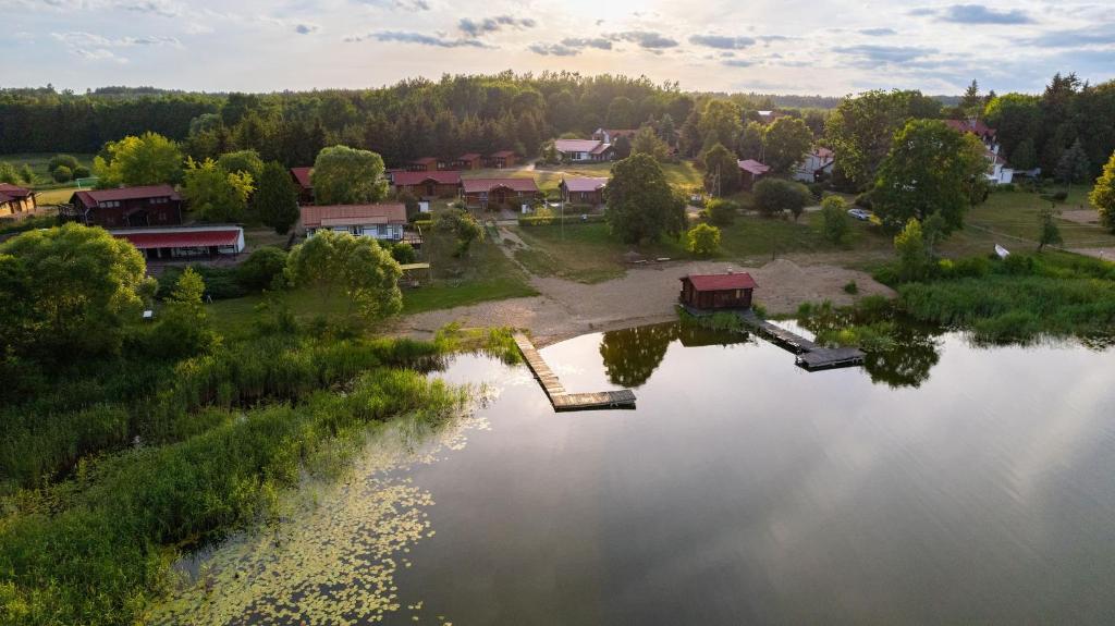 an aerial view of a lake with a resort at Star-Dadaj Lake Camp in Barczewo