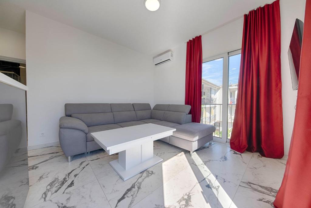a living room with a couch and a table at MEMO's DUKAT in Šušanj
