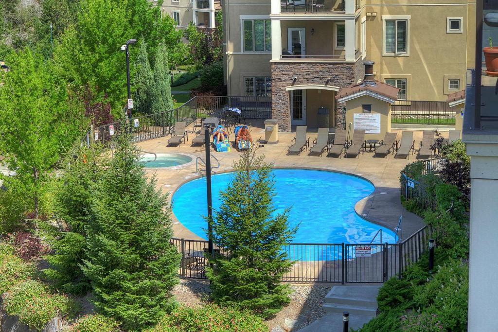 an overhead view of a swimming pool in front of a house at Pool-View condo at Pinnacle Pointe Resort-Sleeps 6 in Kelowna
