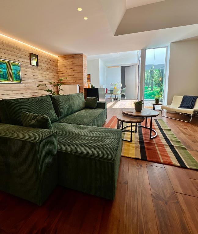 a living room with a green couch and a table at Studio 17 in Ghent