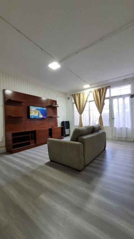 a living room with a couch and a flat screen tv at Hermosos monoambientes a estrenar in Comodoro Rivadavia