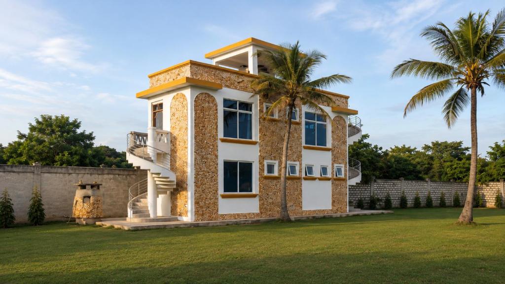a house with a palm tree in a yard at Harlequin Diani in Diani Beach