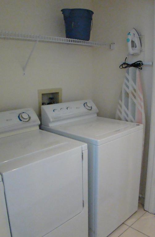 two washing machines and a washer and dryer in a laundry room at Vanderbilt Beach Resort in Naples