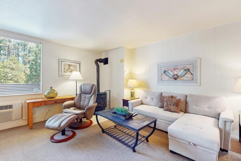 a living room with a white couch and a chair at Second-floor condo with 2 shared pools hot tub sauna in South Lake Tahoe