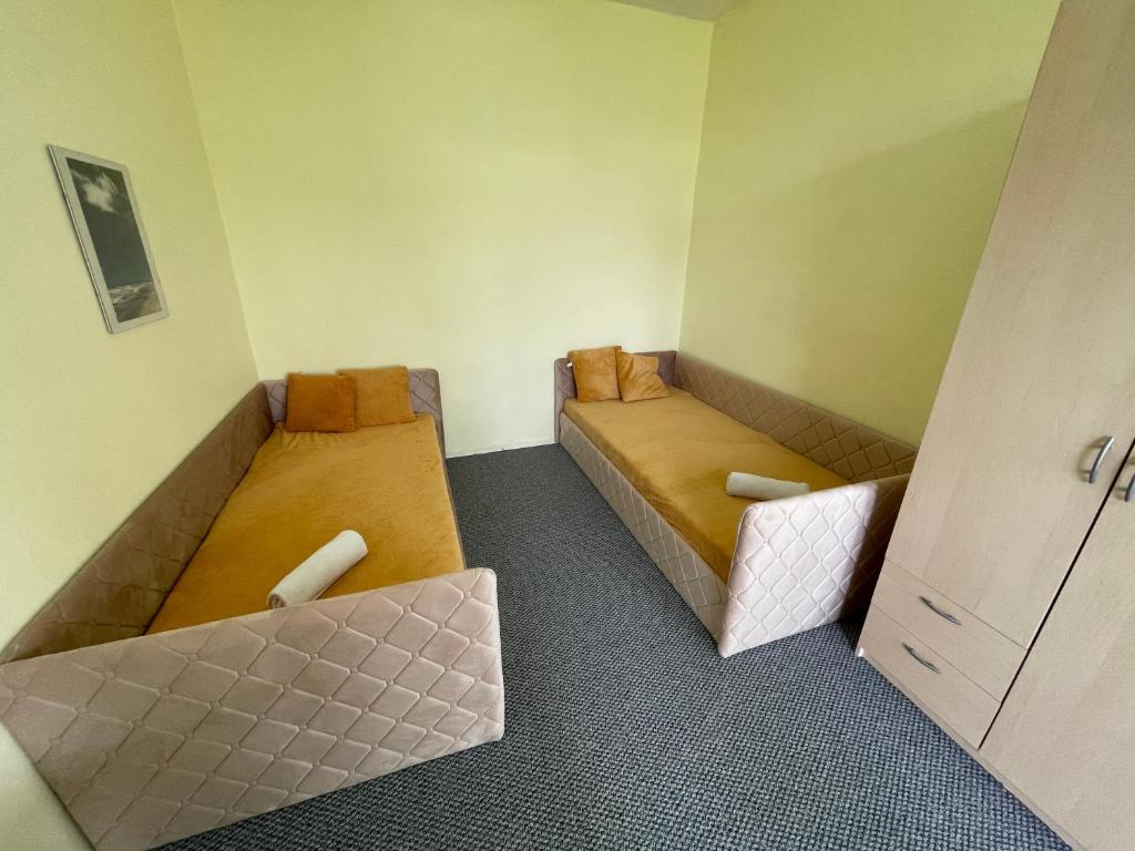 a small room with two beds in it at MiegOK777 in Palanga