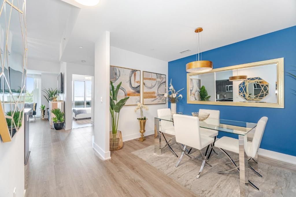 a dining room with blue walls and a table and chairs at Waterfront Luxury Condo in Toronto
