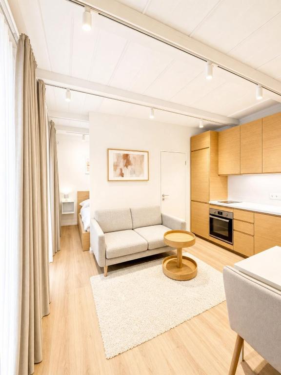 a living room with a couch and a table at Superb Old Town Apartment in Klaipėda