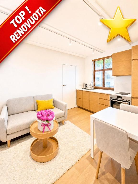 a living room with a couch and a table at Express Guest House in Klaipėda