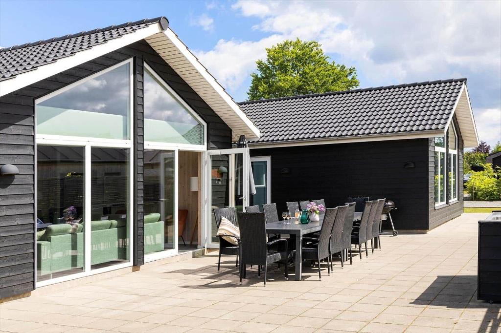 a patio with a table and chairs on it at 8876-Glesborg-Strandvejen-43 in Fjellerup Strand