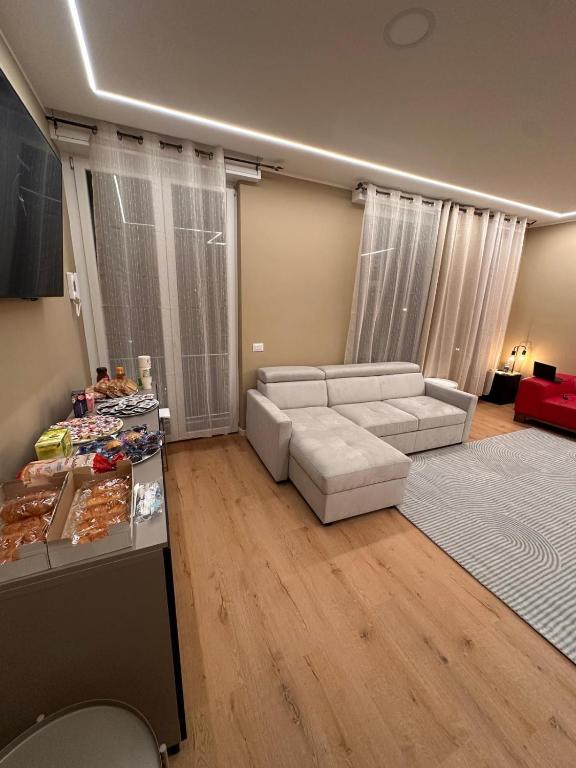 a living room with a white couch and a table at 88 Destination in Treviglio