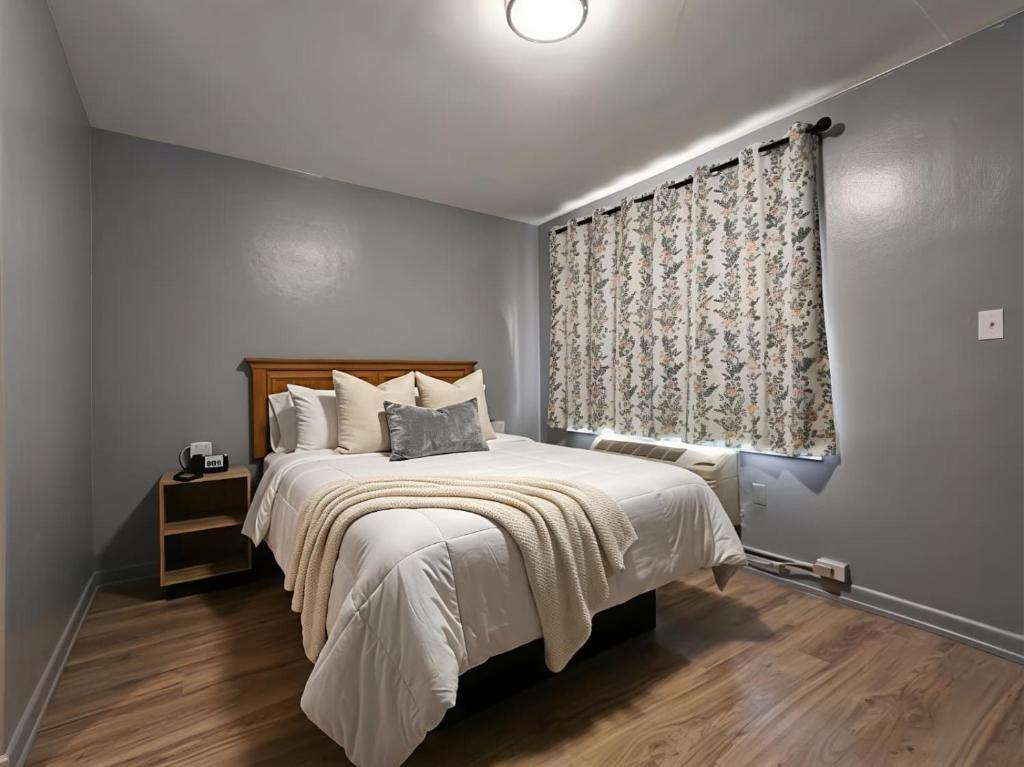 a bedroom with a large bed and a window at Mark Twain Motor Inn in Elmira