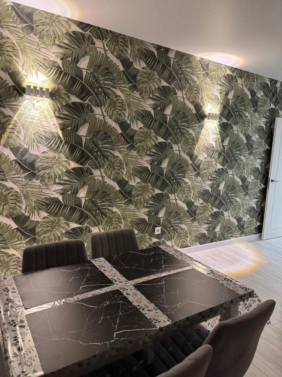a conference room with a black table with chairs at Modern & Quiet Apartment in Chişinău