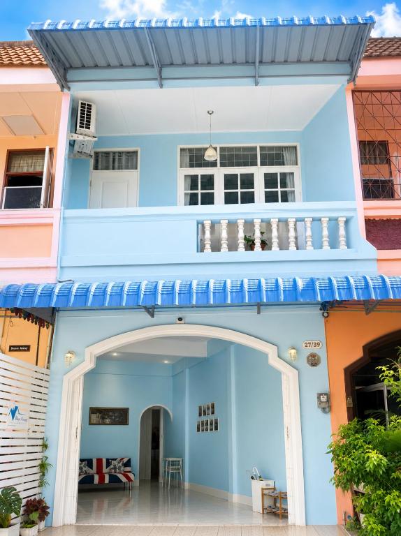 a blue house with an archway in front of it at Blue House Hat Yai in Hat Yai