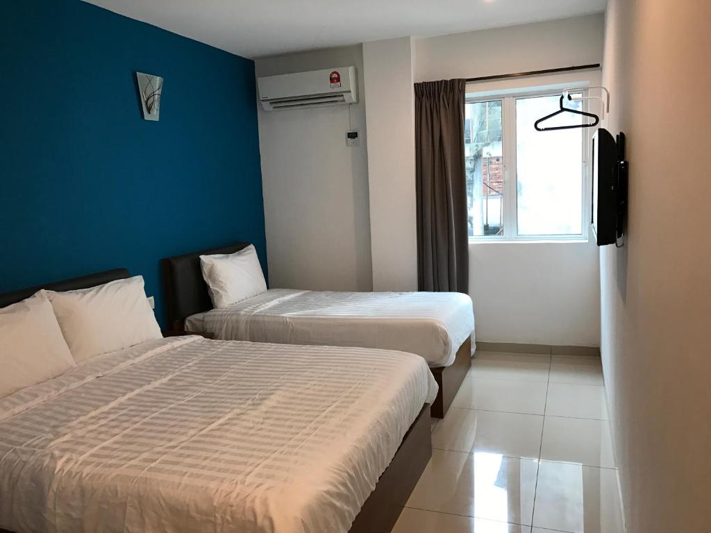 Postel nebo postele na pokoji v ubytování Brezza Hotel Sitiawan
