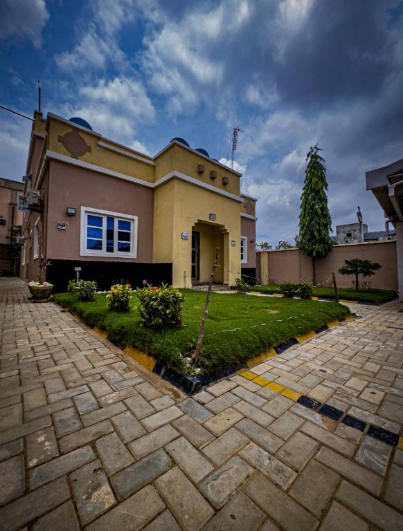 a large house with a driveway in front of it at Zamin Suites in Kano