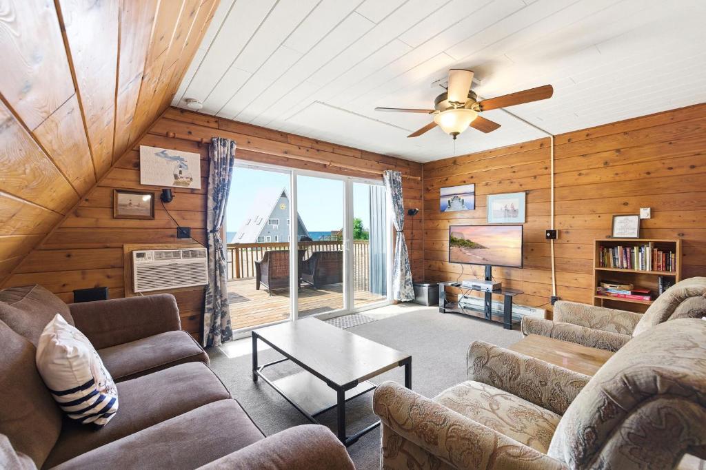 a living room with a couch and a ceiling fan at Chalet #25 in Stevensville