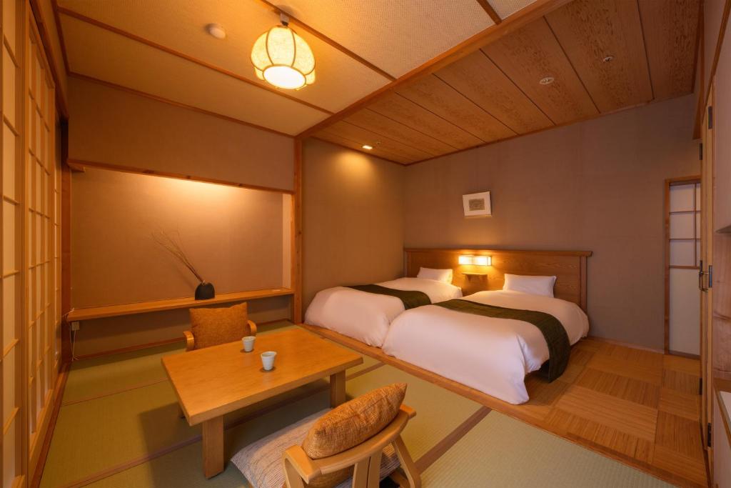 Postel nebo postele na pokoji v ubytování Sakunami Onsen Yuzukushi Salon Ichinobo