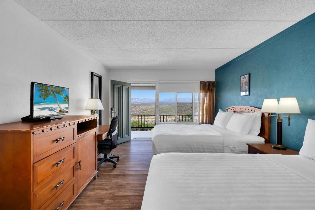 a hotel room with two beds and a television at Tombstone Lookout Lodge, SureStay Collection by Best Western in Tombstone