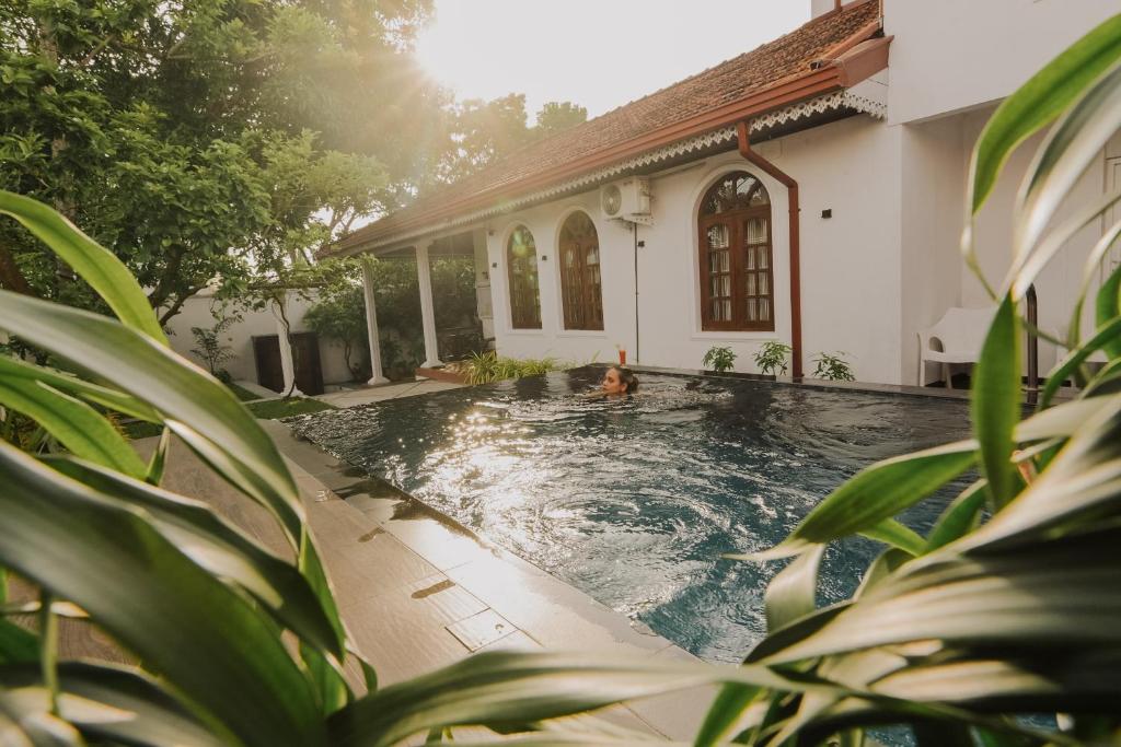 a swimming pool in front of a house at Airport Transit Villa in Minuwangoda