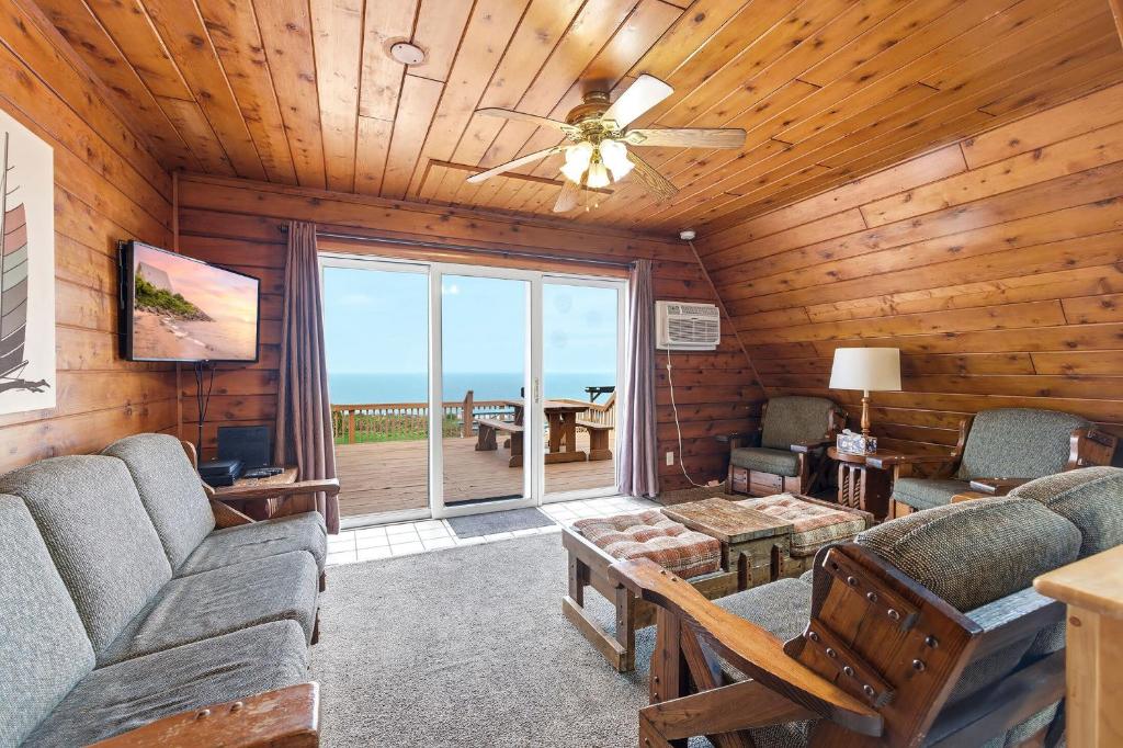 a living room with a couch and a ceiling fan at Chalet #18 in Stevensville