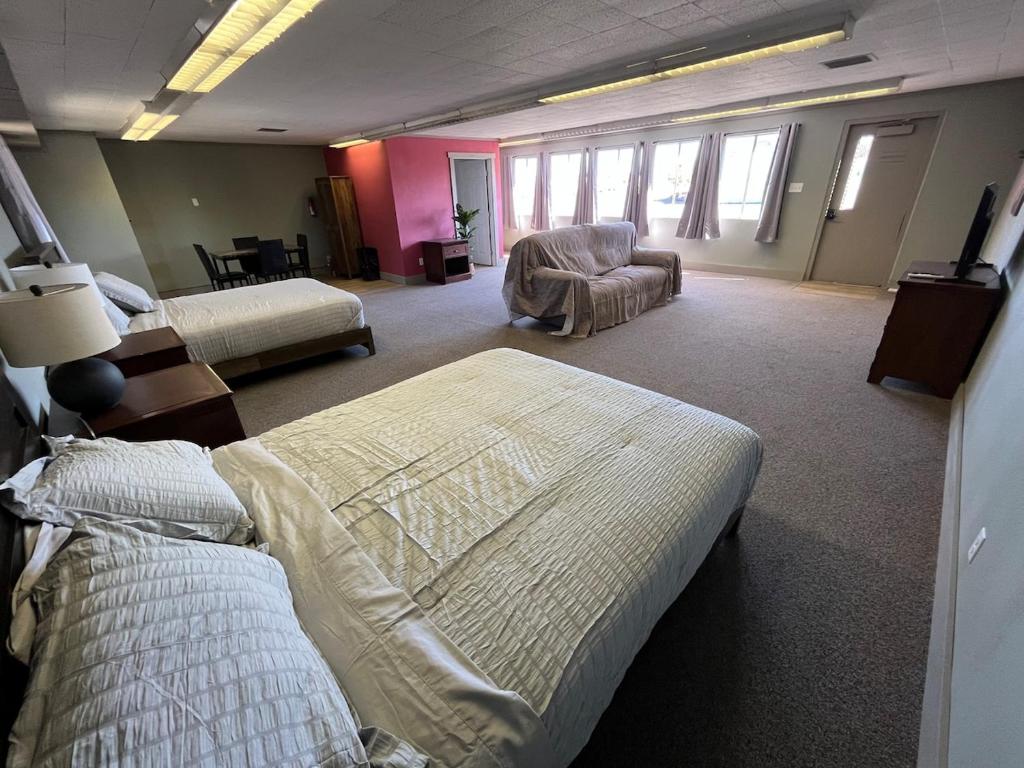 a hotel room with two beds and a chair at House # 9 in Las Vegas