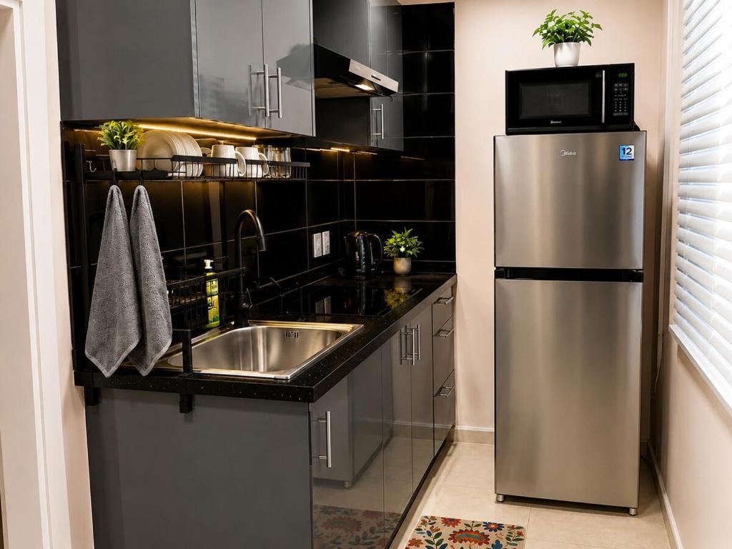 a kitchen with a stainless steel refrigerator and a sink at DOLFIJN STUDIOS 4 Spacious 2BR Apartment Fast WiFi AC North Paramaribo in Paramaribo
