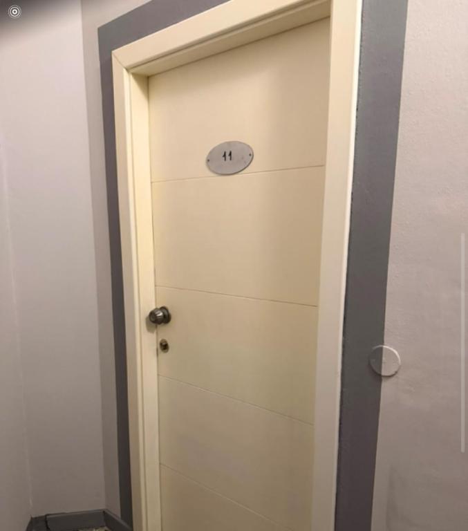a door with a clock on top of it at La voglia albergo in Villanova sullʼArda