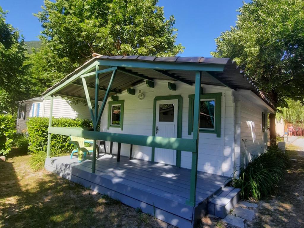 a tiny house with a porch and a deck at Chalet - Animaux admis - 4 pers. - API-1-52-2942 in Annot