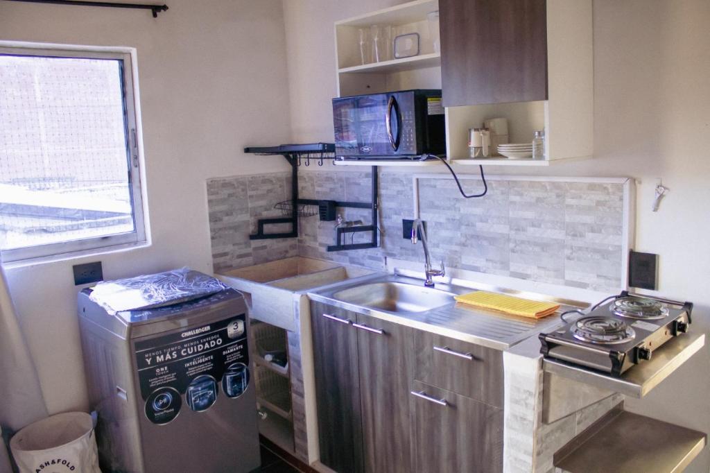 a small kitchen with a sink and a stove at Aparta estudio in Itagüí