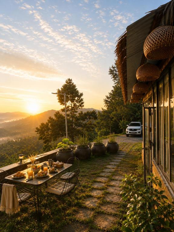 a table on the side of a house with the sunset at THỎ NON GARDEN CLOUDY OCEAN VIEW in Blao Srê
