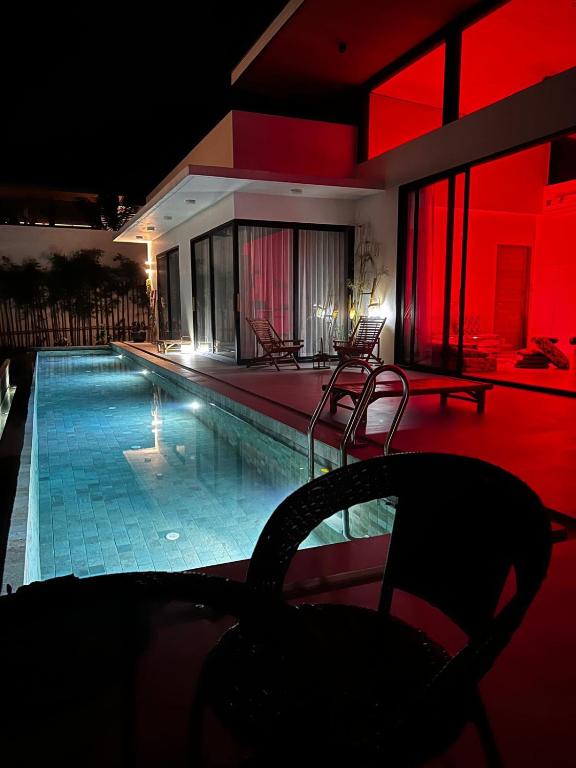 a swimming pool in a house with red lighting at VILLA 3 CHAMBRES a partager in Nathon Bay