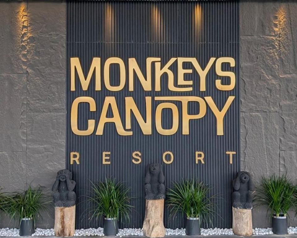 a sign for a monkeyagencyagencyreagent on a building at Monkeys Canopy Resort in Kajang