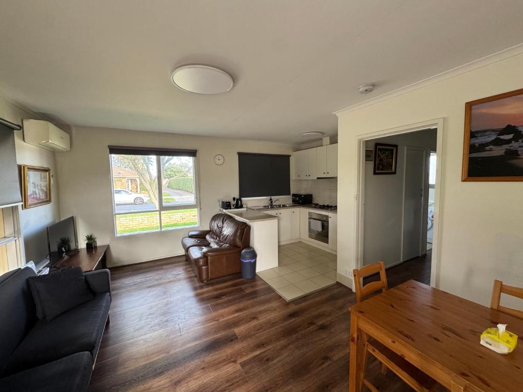 a living room with a couch and a table at Ideal Melbourne Seaside Home in Mentone