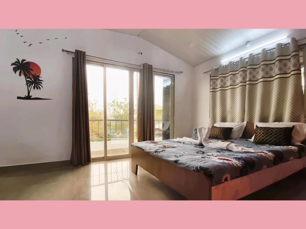 a bedroom with a large bed and a large window at The Grand Crest Residency in Panchgani