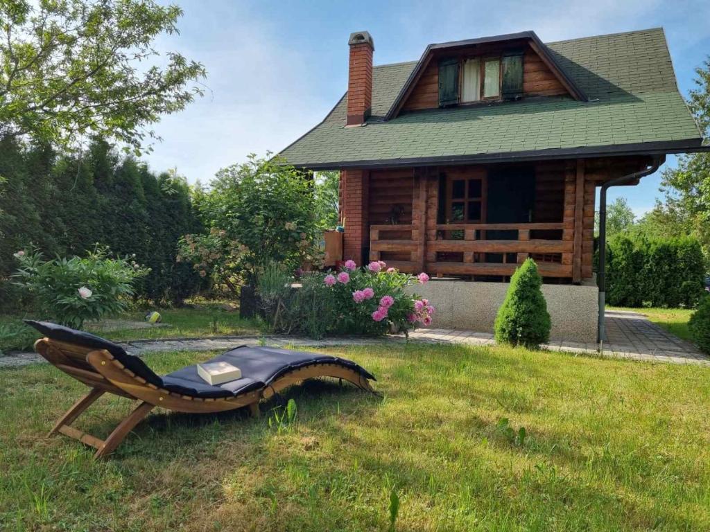 a bench in the grass in front of a house at Holiday Home Geppetto in Gornji Velemerić