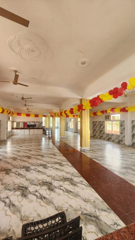a large room with a dance floor with colorful decorations at BRAHMANCHAL guest house in Barsāna