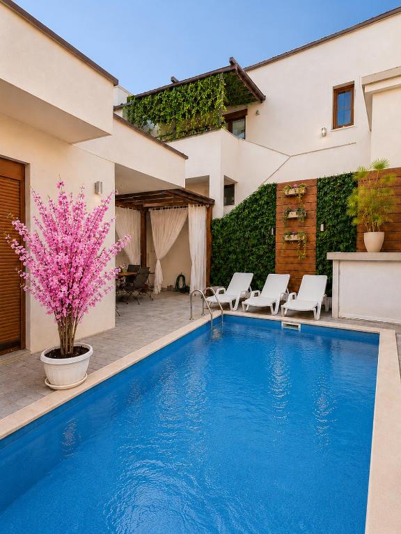 a swimming pool in front of a house at Villa Diamond in Mostar