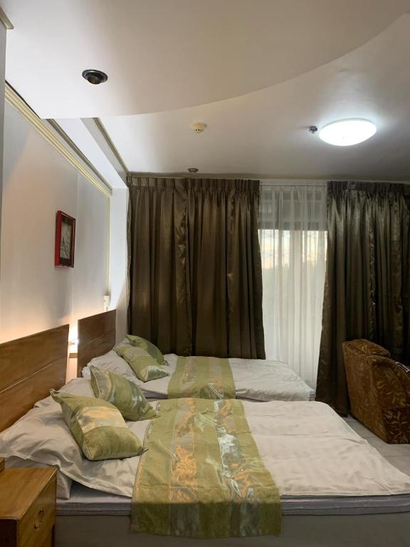 a bedroom with two beds and a window at Dream Garden Hotel in Solano