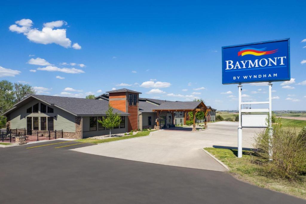 a sign in front of a building with a baymont sign at Baymont by Wyndham Oacoma in Oacoma